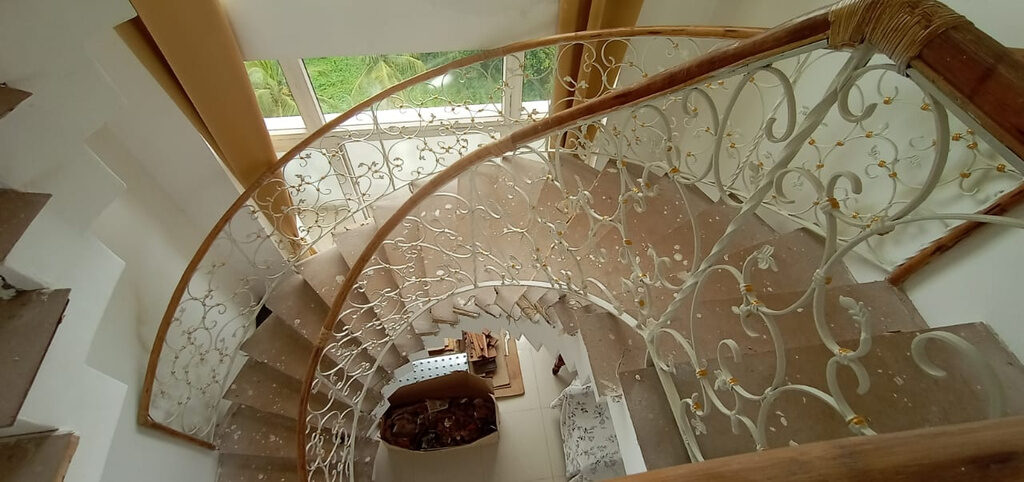 Customised wrought iron helical staircase railing, Thrissur residence